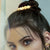 Women with bun wearing gold plated Queen Post Hair accessory 