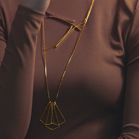 Women wearing necklace Hanging Tripod made with Sterling Silver Gold Plated