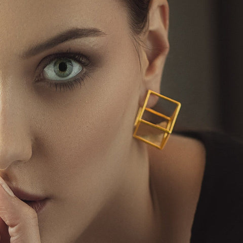 Half zoomed face of Women wearing Obnoxious Cube Sterling Silver Gold Plated Earings