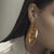 Woman's Ear wearing Wiggling Pipeline Sterling Silver Gold Plated Earring