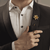 Man in Black suit wearing The Rosette Gold Polished Lapel Pins