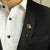 Man in Black Suit White shirt wearing Gold Polished The Quoin Lapel Pins for Men's Formal Wear