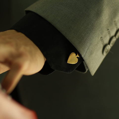 Man's Hand wearing The Spade Gold Polished Cufflinks for Poker Players